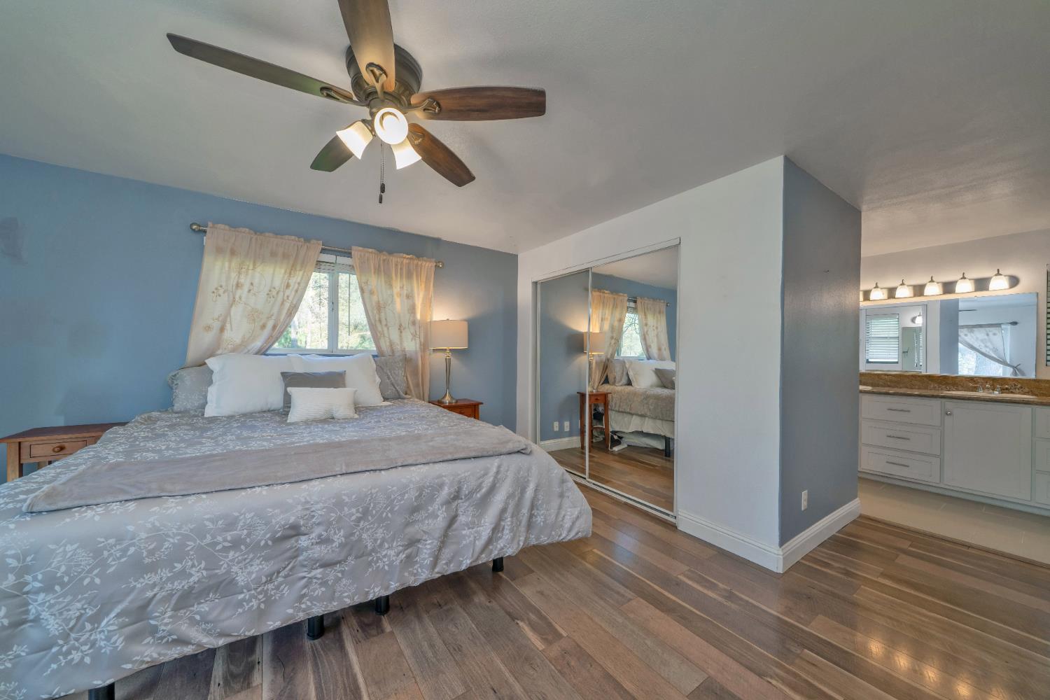 2869 Cascade Trail Cool, CA 95614 - Photo 4 of 80 a bedroom with a large bed a chandelier and dresser