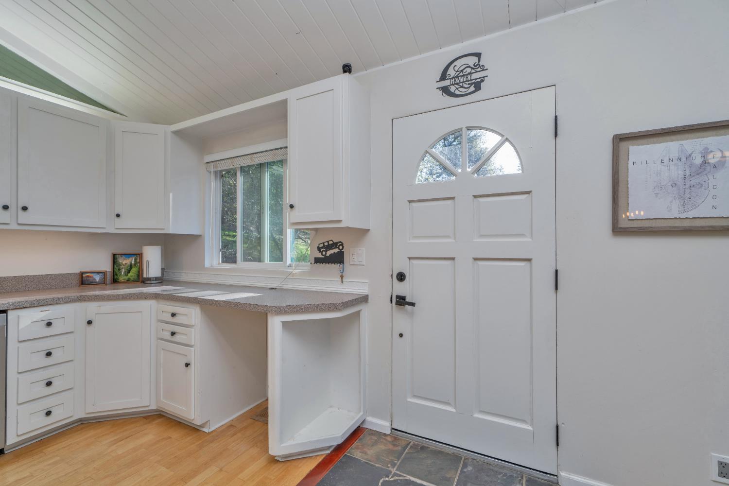 2869 Cascade Trail Cool, CA 95614 - Photo 5 of 80 a kitchen with white cabinets and wooden floor