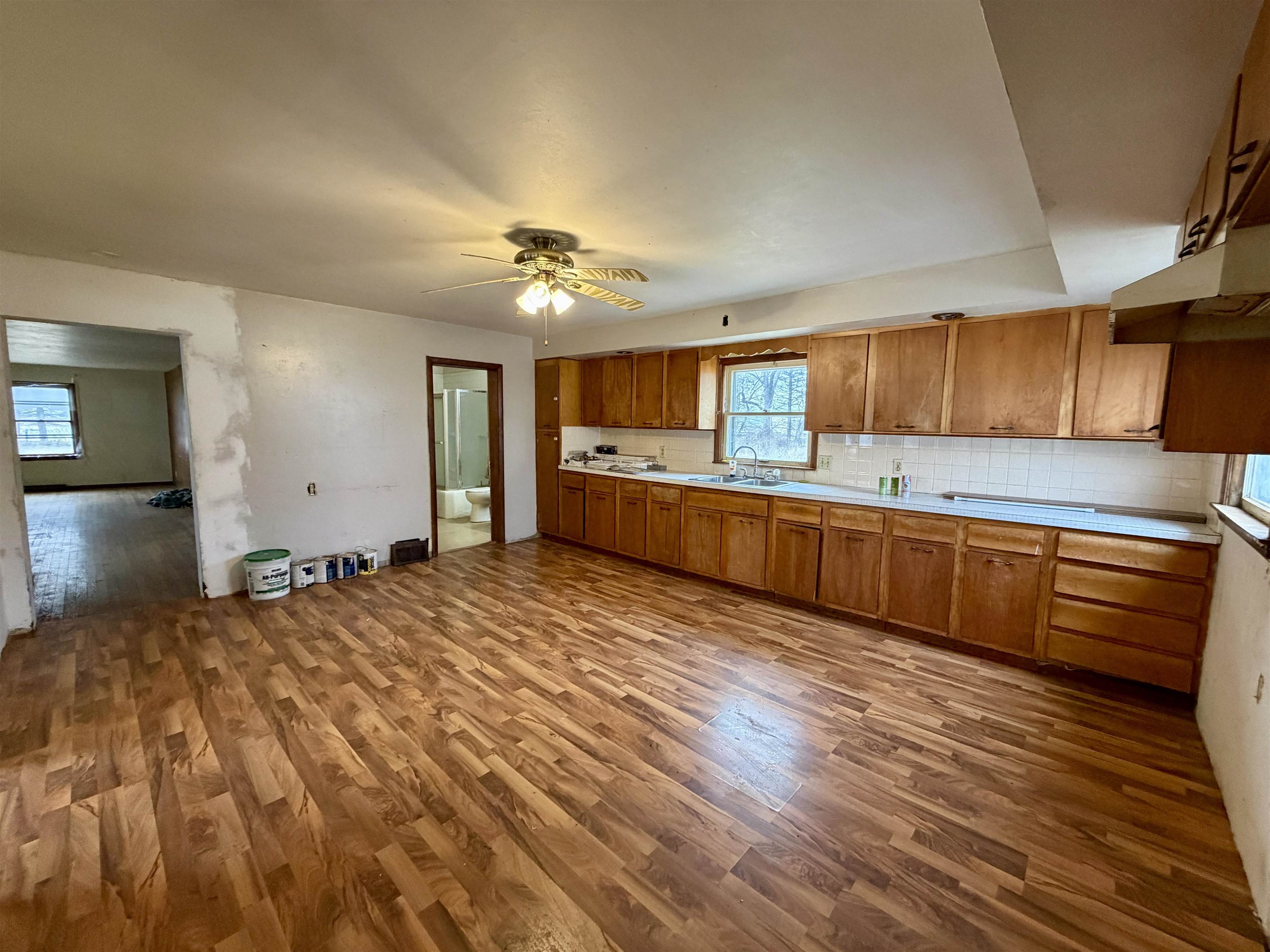3517 North Henderson Road Freeport, IL 61032 - Photo 11 of 26 a kitchen with stainless steel appliances granite countertop a sink cabinets and wooden floor