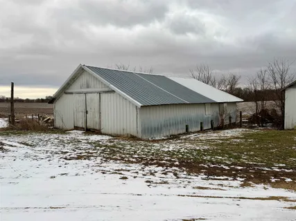 a view of a house with a yard covered in snow