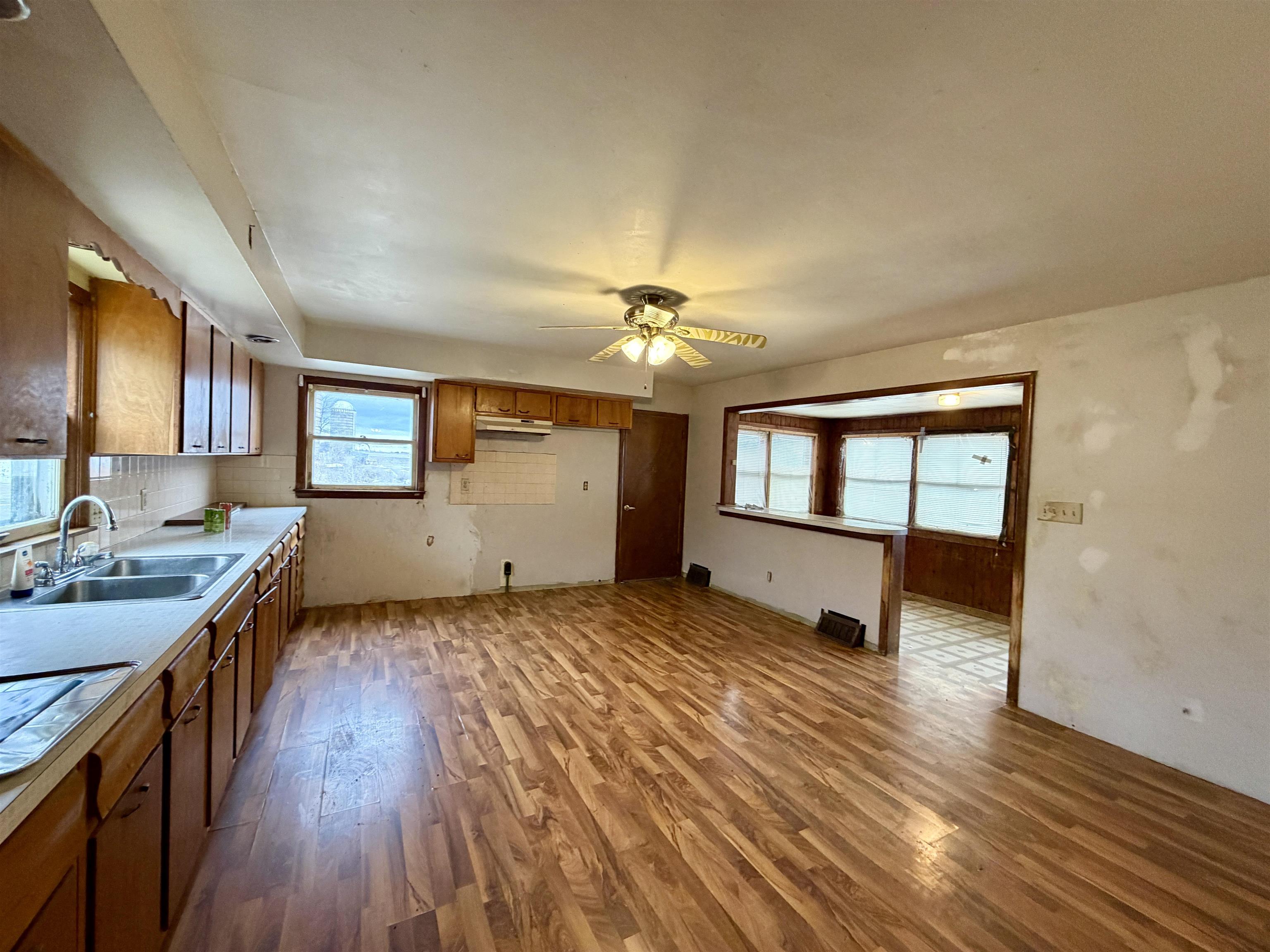 3517 North Henderson Road Freeport, IL 61032 - Photo 9 of 26 a view of a kitchen with a sink cabinets and wooden floor