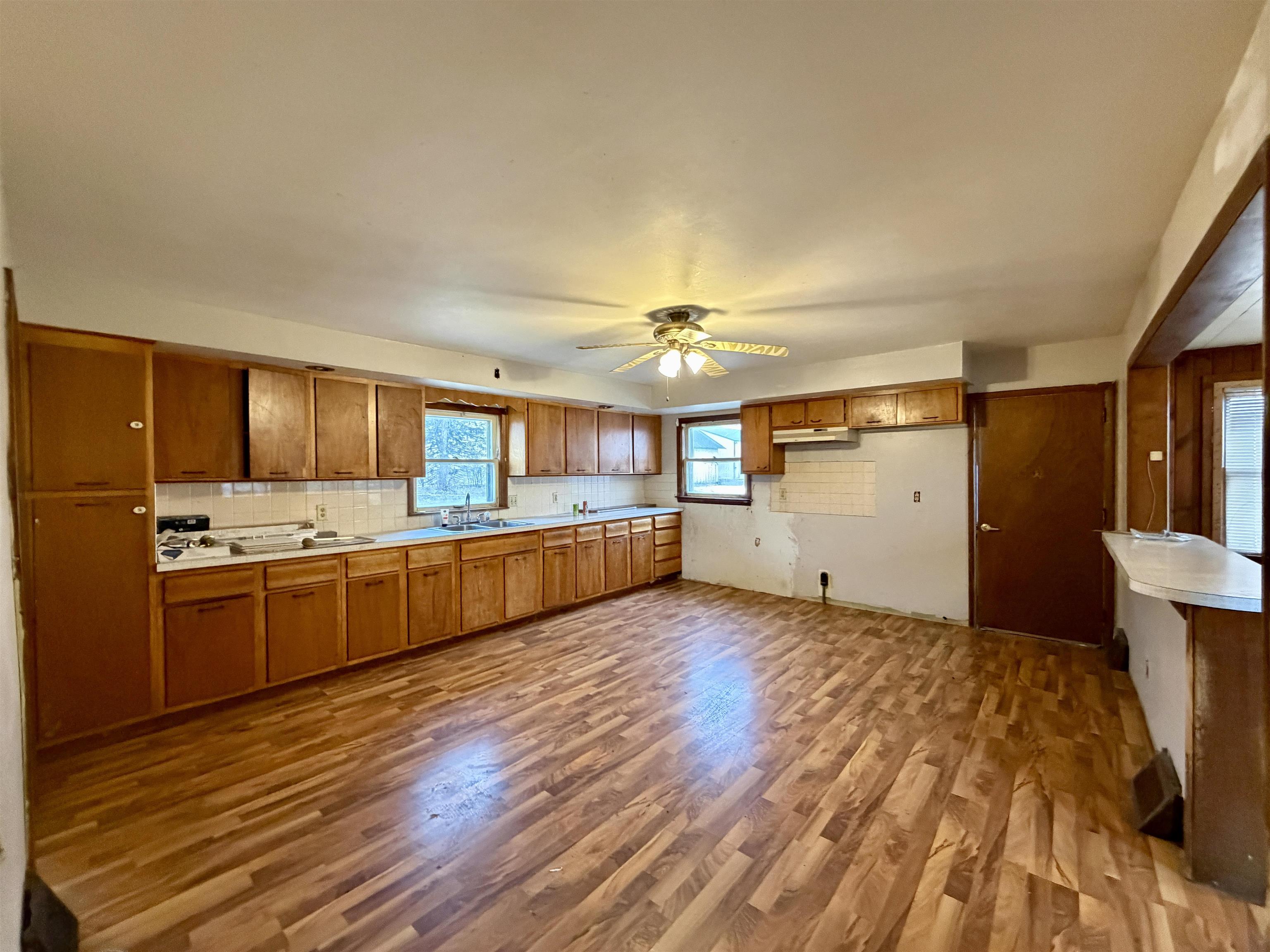 3517 North Henderson Road Freeport, IL 61032 - Photo 10 of 26 a large kitchen with a wooden floor and cabinets