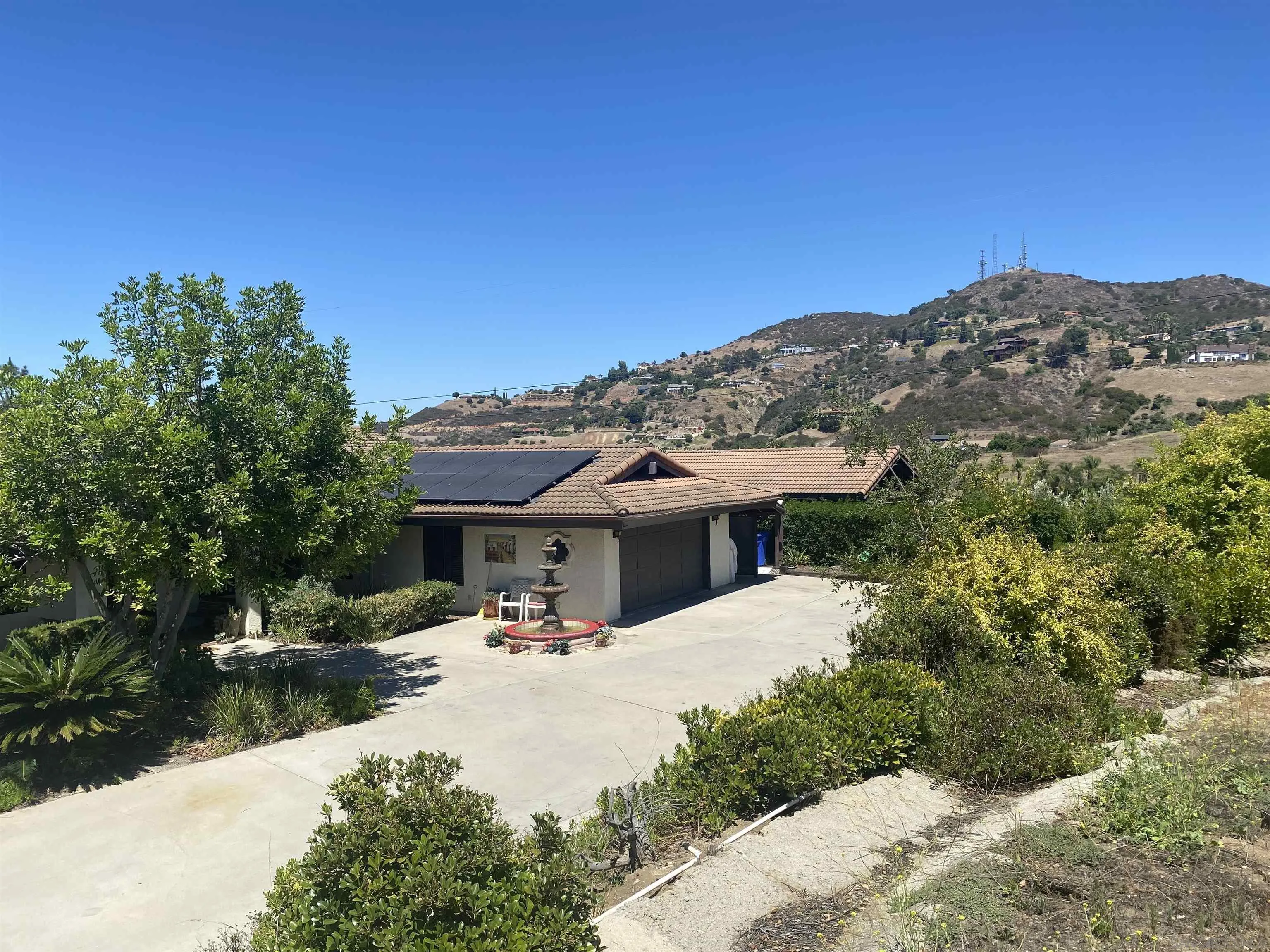 1335 Sunny Heights Road Fallbrook, CA 92028 - Photo 2 of 9 a view of the house with palm trees