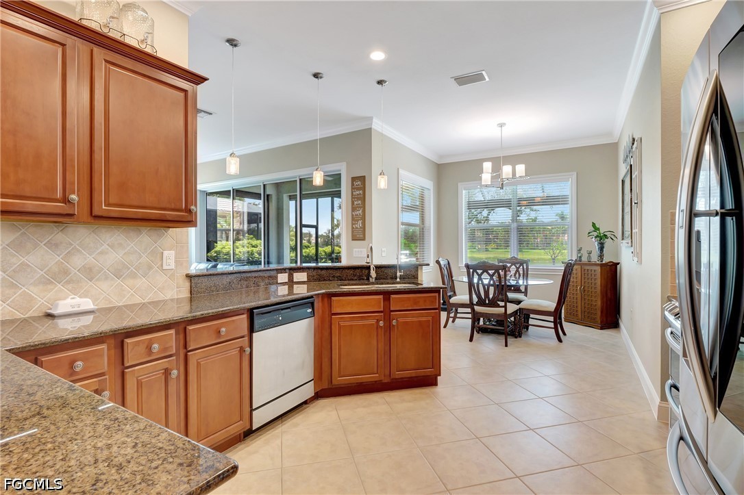 11230 Suffield Street Fort Myers, FL 33913 - Photo 12 of 42 a kitchen with stainless steel appliances granite countertop sink stove and refrigerator