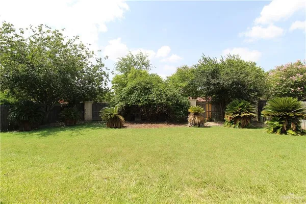 a view of a house with a yard and garage