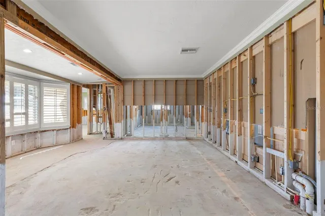 an empty room with sliding door and windows