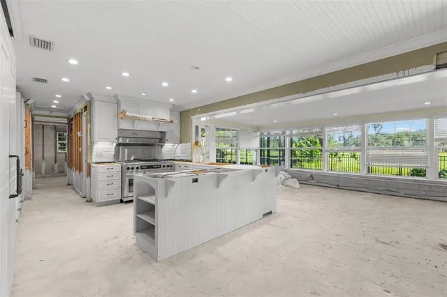 a view of kitchen with stainless steel appliances kitchen island microwave and stove