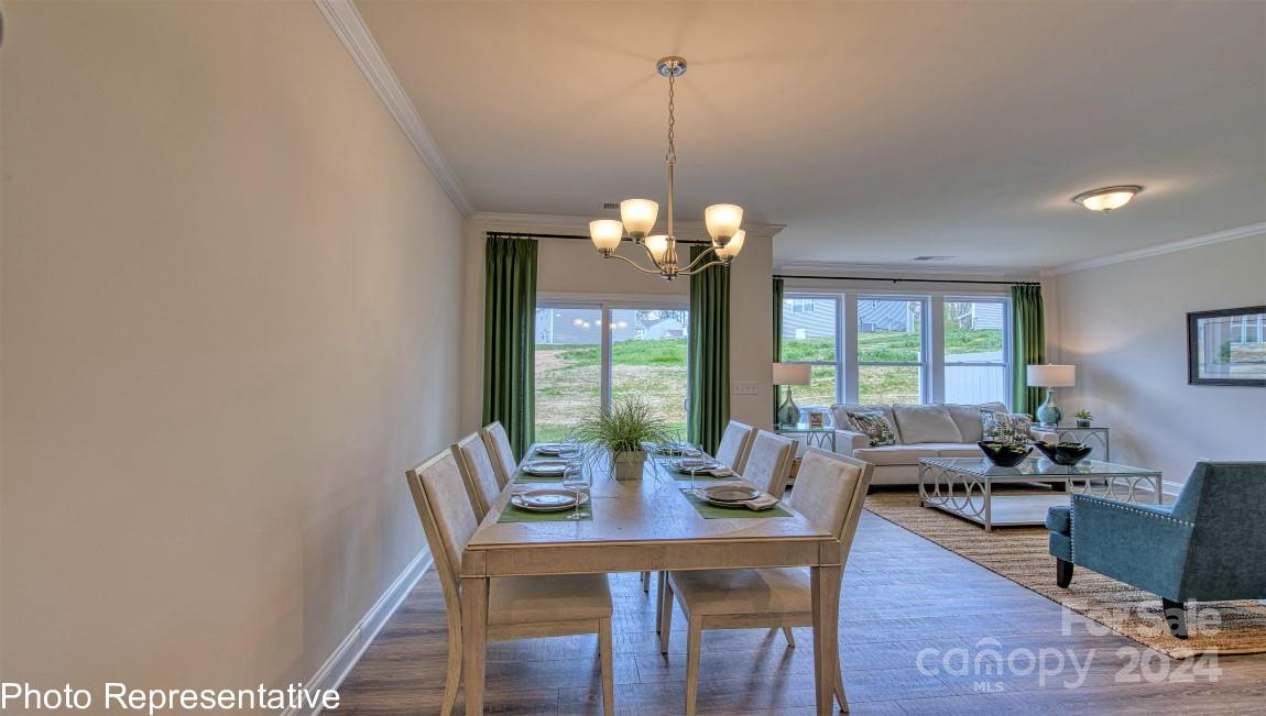 474 Wheatfield Road Fletcher, NC 28732 - Photo 20 of 45 a dining room with furniture a chandelier and wooden floor