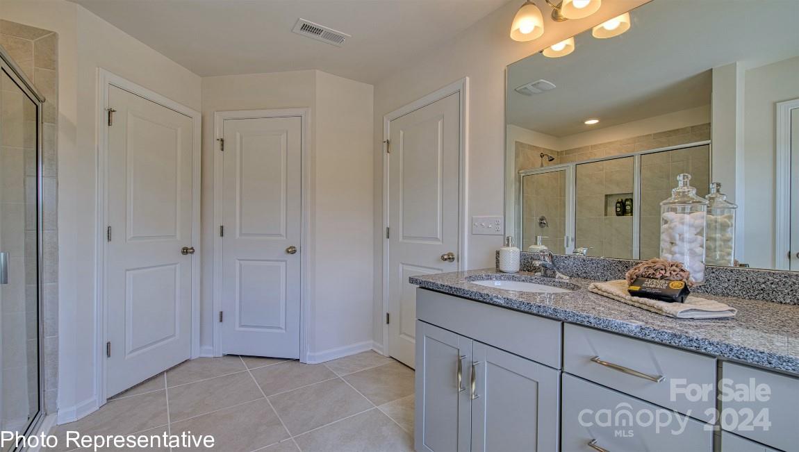 474 Wheatfield Road Fletcher, NC 28732 - Photo 32 of 45 a bathroom with a granite countertop sink and a mirror