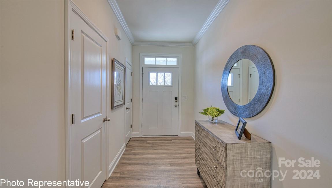 474 Wheatfield Road Fletcher, NC 28732 - Photo 5 of 45 a view of a hallway with wooden floor and a mirror