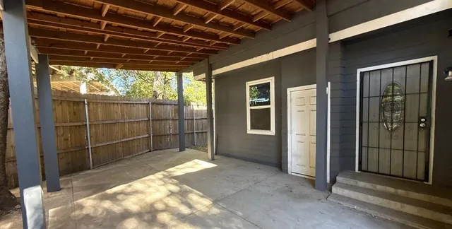 a view of a backyard with wooden floor and a window