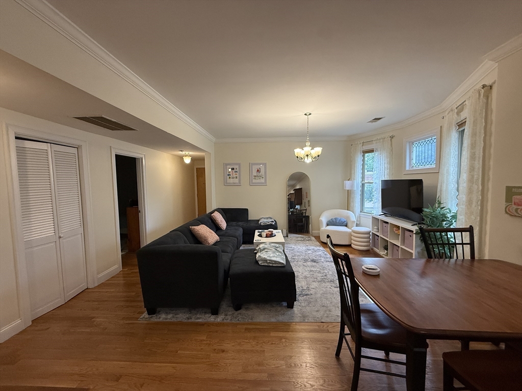 106 Chester Street, Unit 2 Boston, MA 02134 - Photo 1 of 9 a living room with furniture a flat screen tv and a table