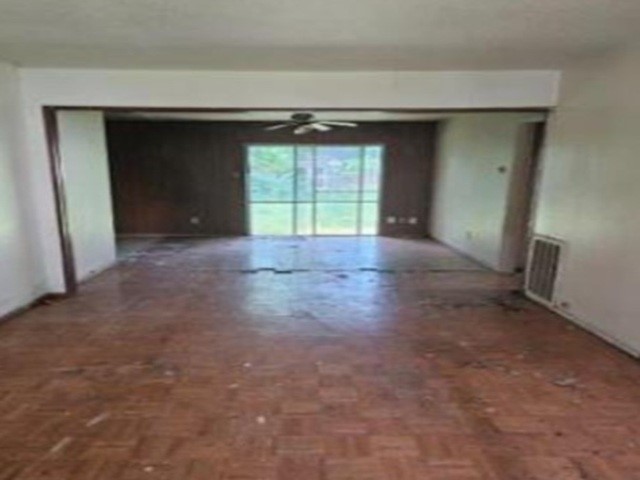 4806 Grapevine Street Houston, TX 77045 - Photo 2 of 13 a view of an empty room with a fireplace and a window