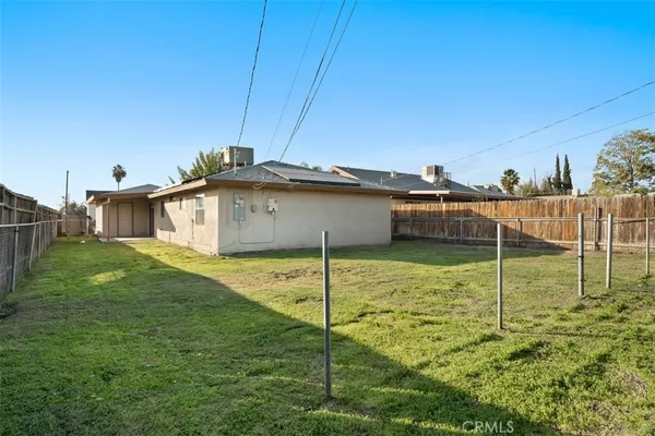 a view of a backyard with table and chairs