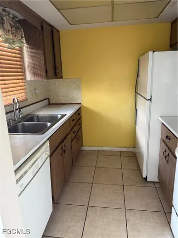 a kitchen with a sink cabinets and a refrigerator