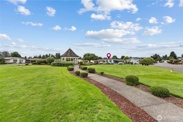 a view of a patio with table and chairs potted plants with floor to ceiling window