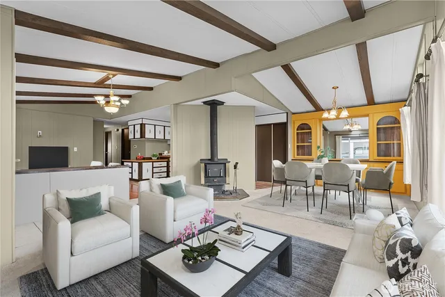 a living room with furniture a rug and a chandelier