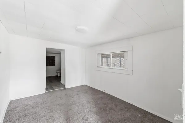a view of a room with a hallway and closet