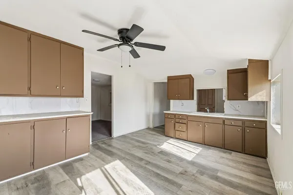 a kitchen with stainless steel appliances granite countertop a sink and cabinets