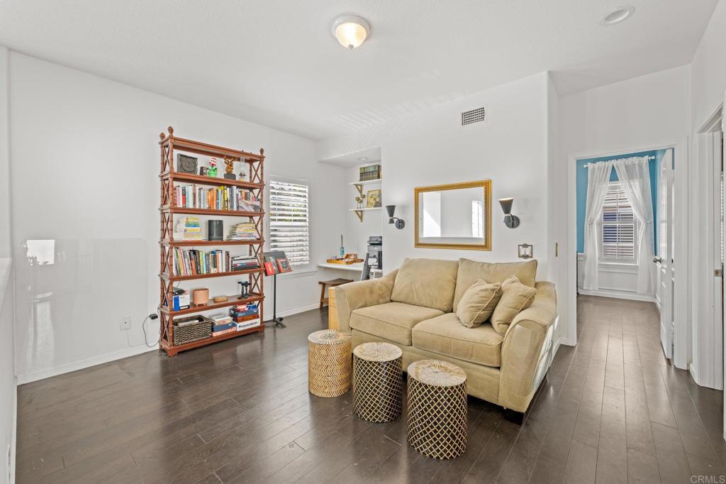 120 Venetia Way Oceanside, CA 92057 - Photo 12 of 32 a living room with furniture and a book shelf