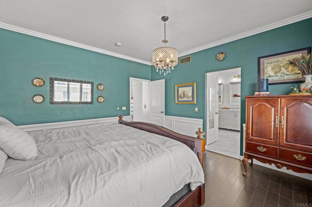 120 Venetia Way Oceanside, CA 92057 - Photo 14 of 32 a spacious bedroom with a bed and a chandelier
