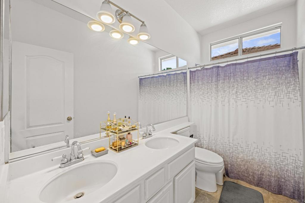 120 Venetia Way Oceanside, CA 92057 - Photo 19 of 32 a bathroom with a sink toilet and vanity