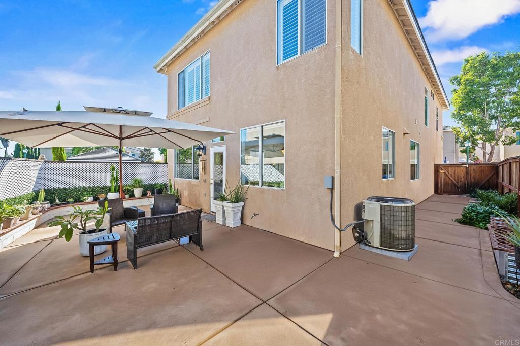120 Venetia Way Oceanside, CA 92057 - Photo 21 of 32 a view of a patio with a table and chairs under an umbrella