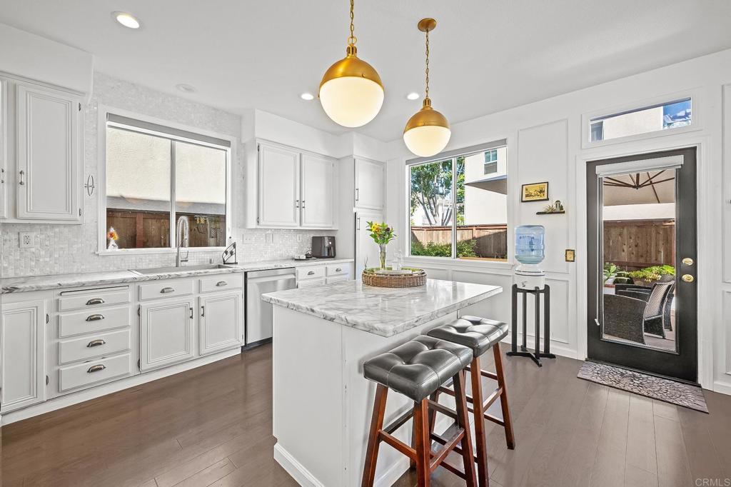 120 Venetia Way Oceanside, CA 92057 - Photo 4 of 32 a kitchen with white cabinets and refrigerator