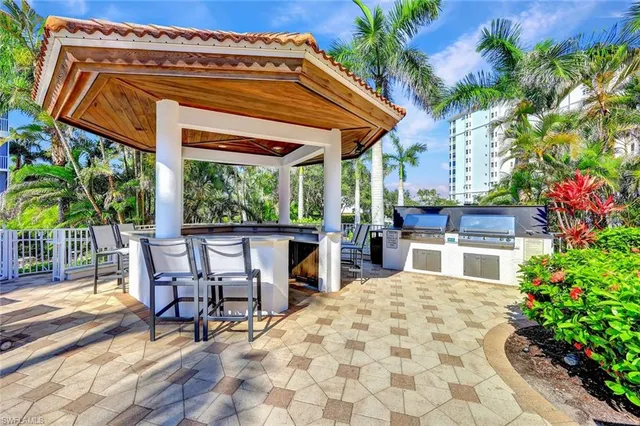 a view of a patio with table and chairs and potted plants