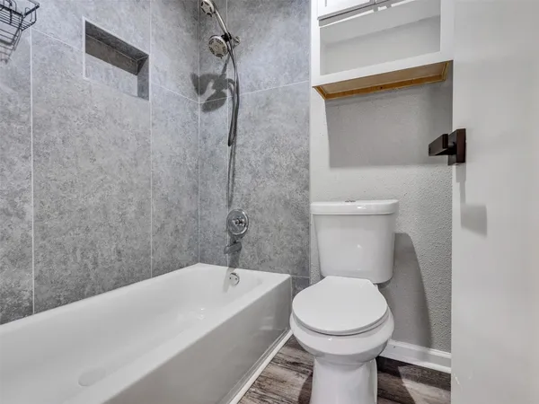 a bathroom with a toilet and a bathtub