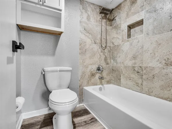 a bathroom with a toilet and a shower