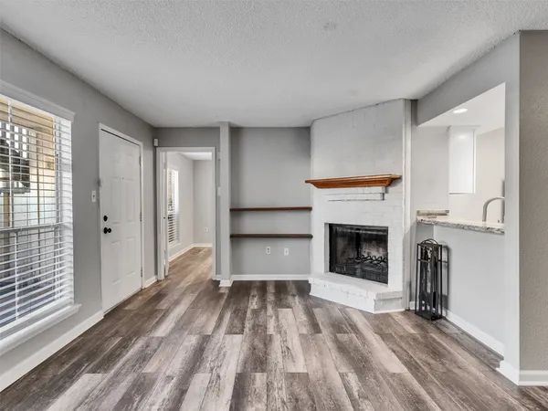 a view of a livingroom with a fireplace and cabinet