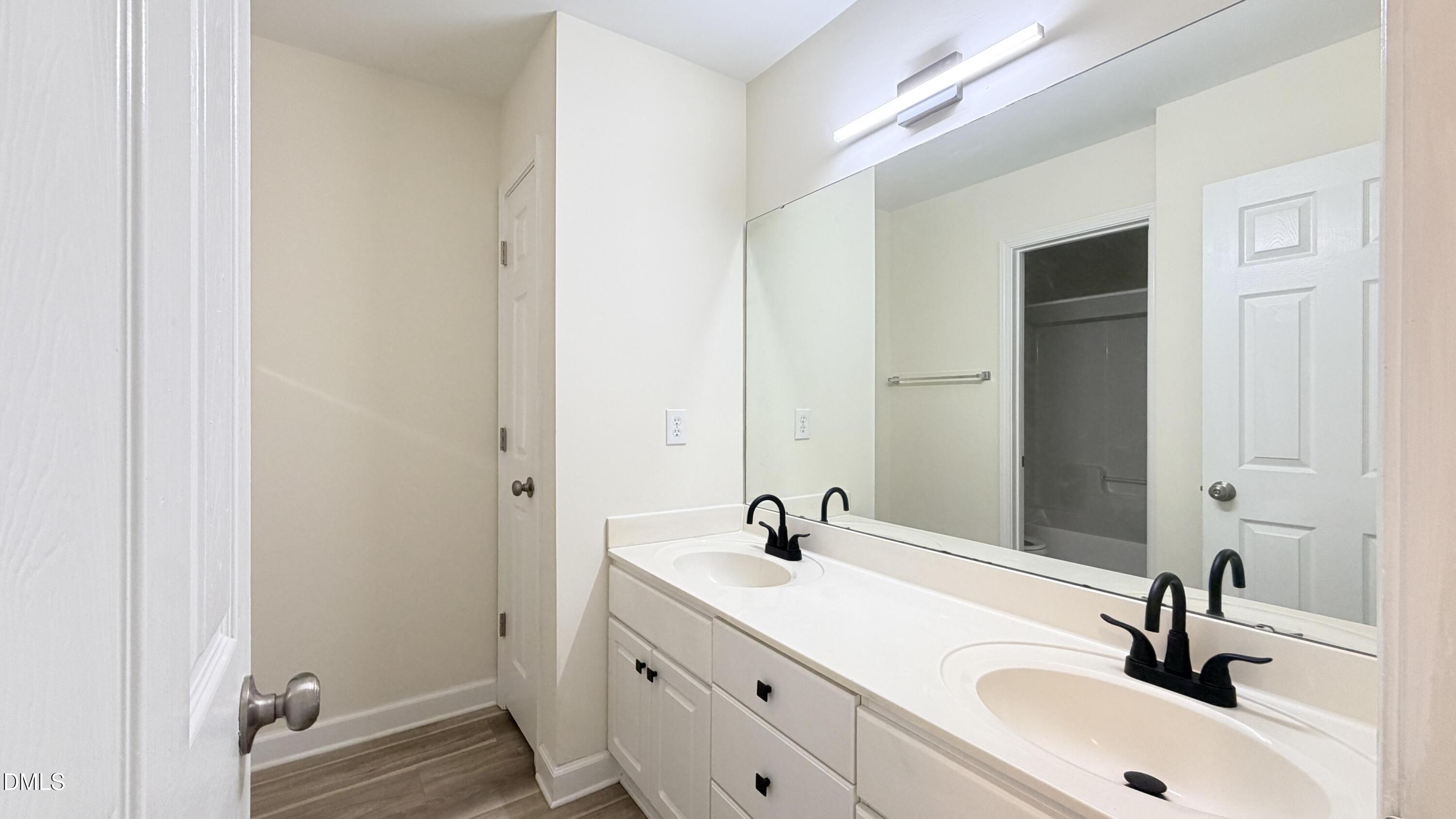 4123 Standing Rock Way Raleigh, NC 27604 - Photo 17 of 29 a bathroom with a sink and a mirror