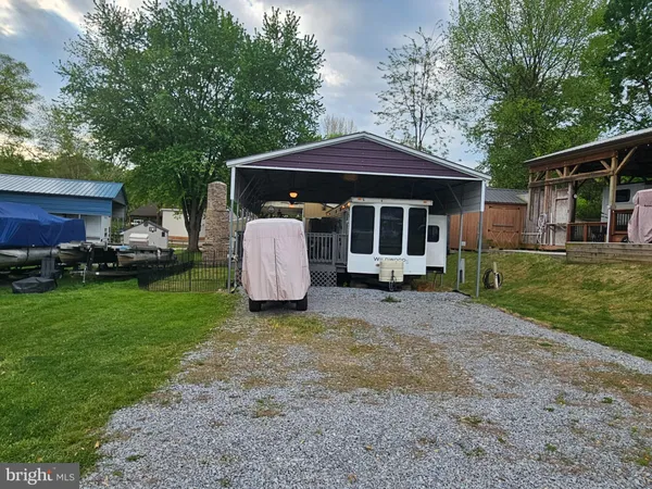 a view of a house with a yard and tree