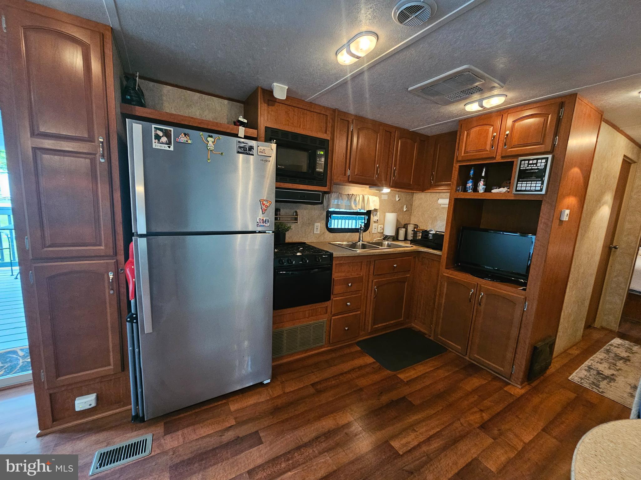 8 Cindy Avenue Falling Waters, WV 25419 - Photo 12 of 32 a kitchen with stainless steel appliances a refrigerator stove and microwave