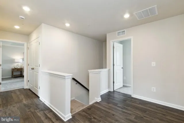 a view of a hallway with white walls