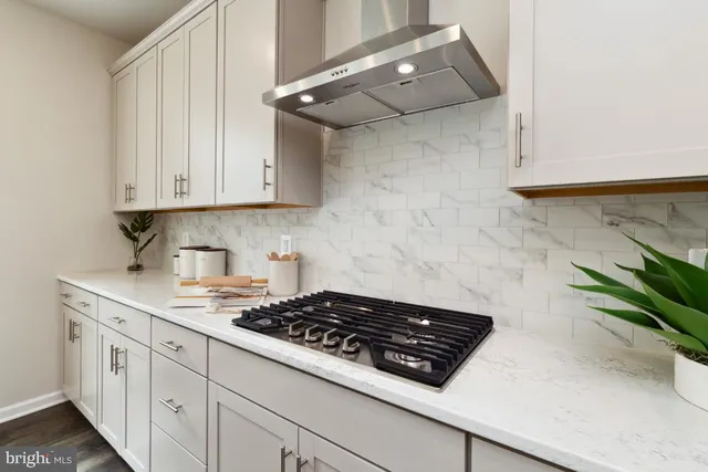 a stove top oven sitting inside of a kitchen