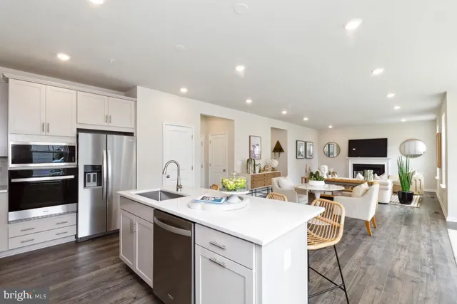 a kitchen with stainless steel appliances kitchen island granite countertop a sink and cabinets
