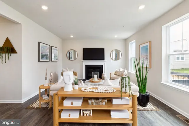 a living room with furniture a fireplace and a window