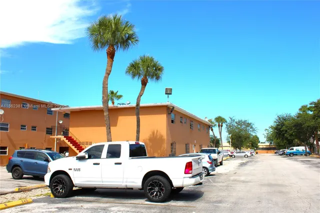 a view of a house with a yard and flower plants
