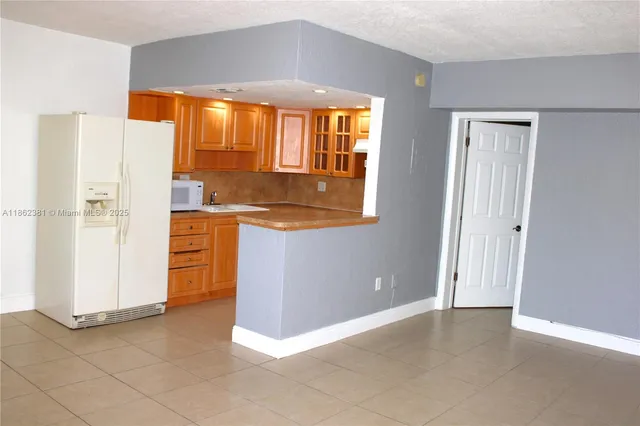 a kitchen with stainless steel appliances a refrigerator and a stove