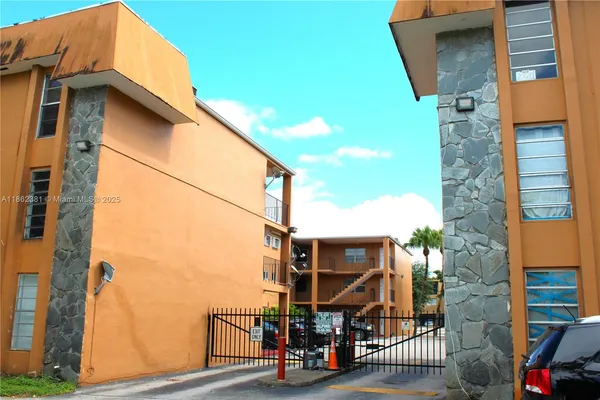 a view of a car park in front of a house