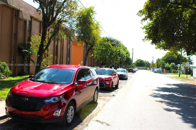 a view of the street with parked cars