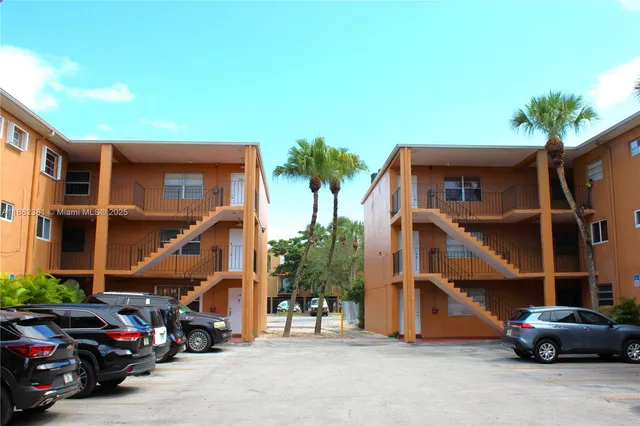 a car parked in front of a white house