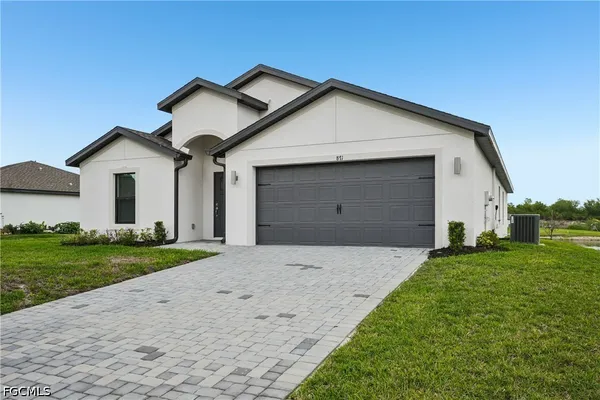 a view of a house with a yard and garage
