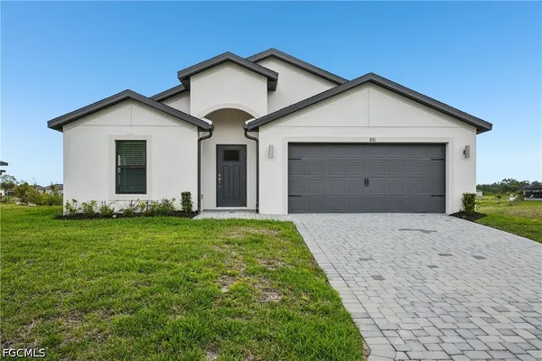 a view of a house with a yard and garage