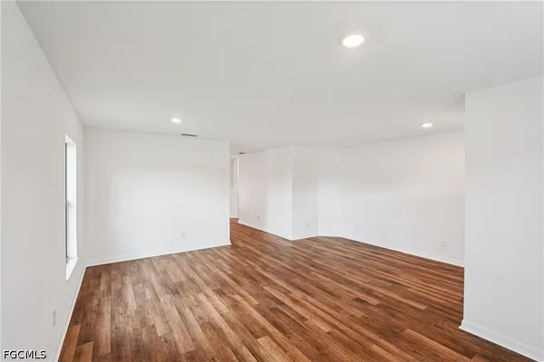 wooden floor in an empty room with a window