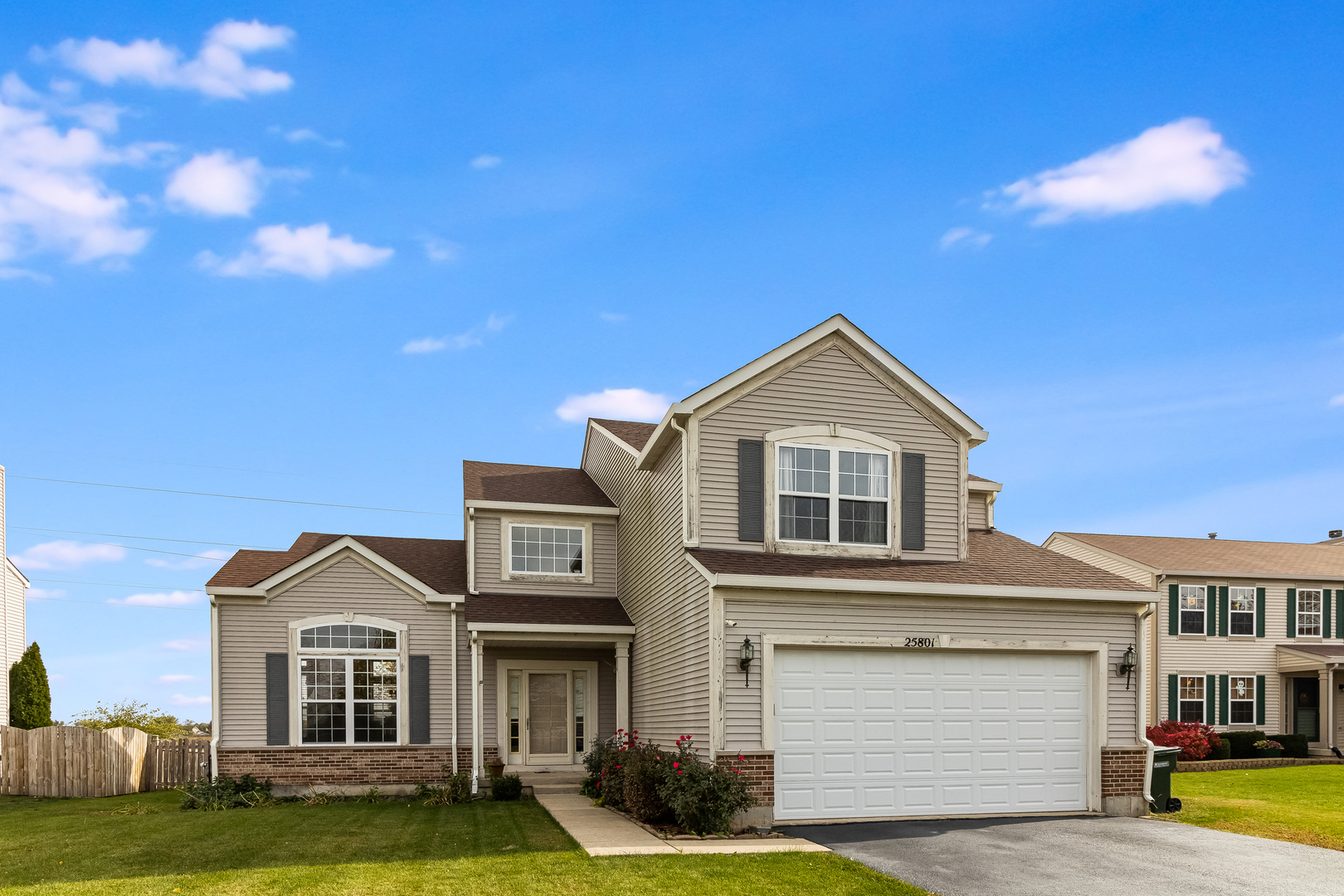 a front view of a house with a yard and garage