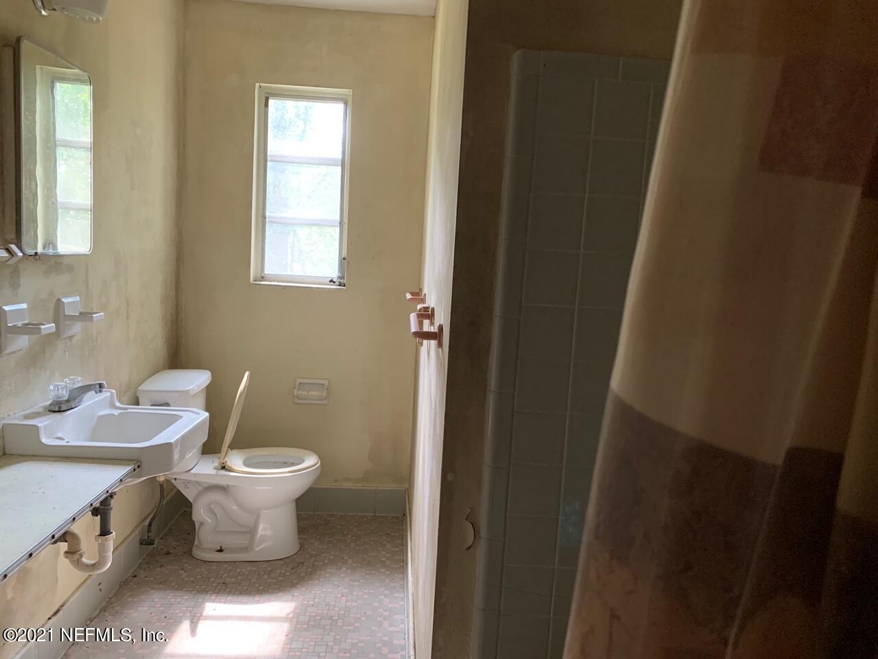 2619 Bywood Road Jacksonville, FL 32211 - Photo 8 of 13 a bathroom with a granite countertop toilet a sink and a mirror