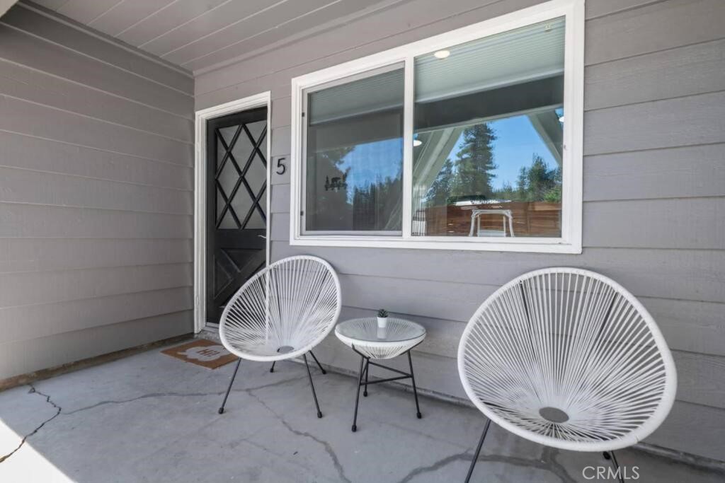 560 Edgemoor Road, Unit 5 Big Bear Lake, CA 92315 - Photo 3 of 10 a view of a room that has a table and chairs